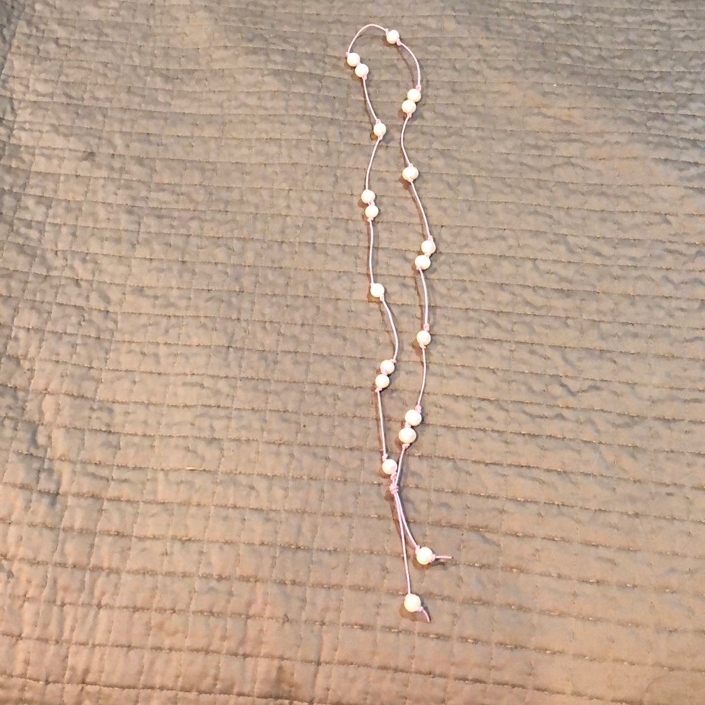 Adorable long, pink pearl necklace.